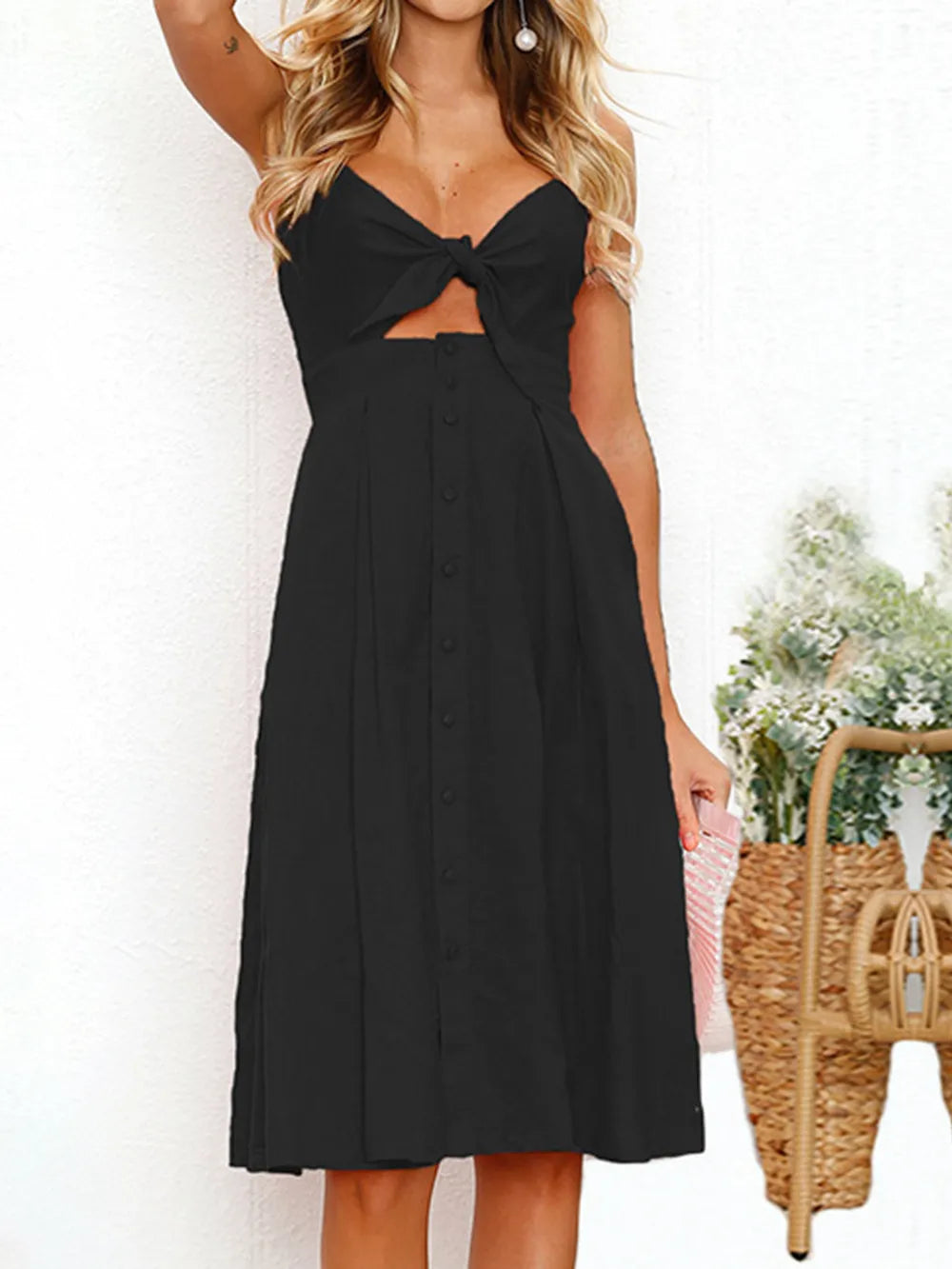 Black cami dress with sweetheart bow cutout and button-front midi skirt