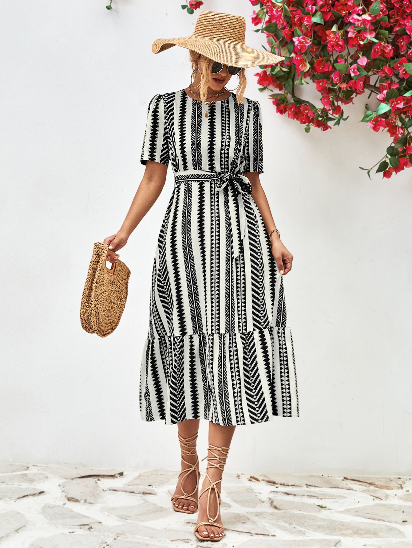 Black striped round-neck puff sleeve dress with tied waist belt, tiered skirt.