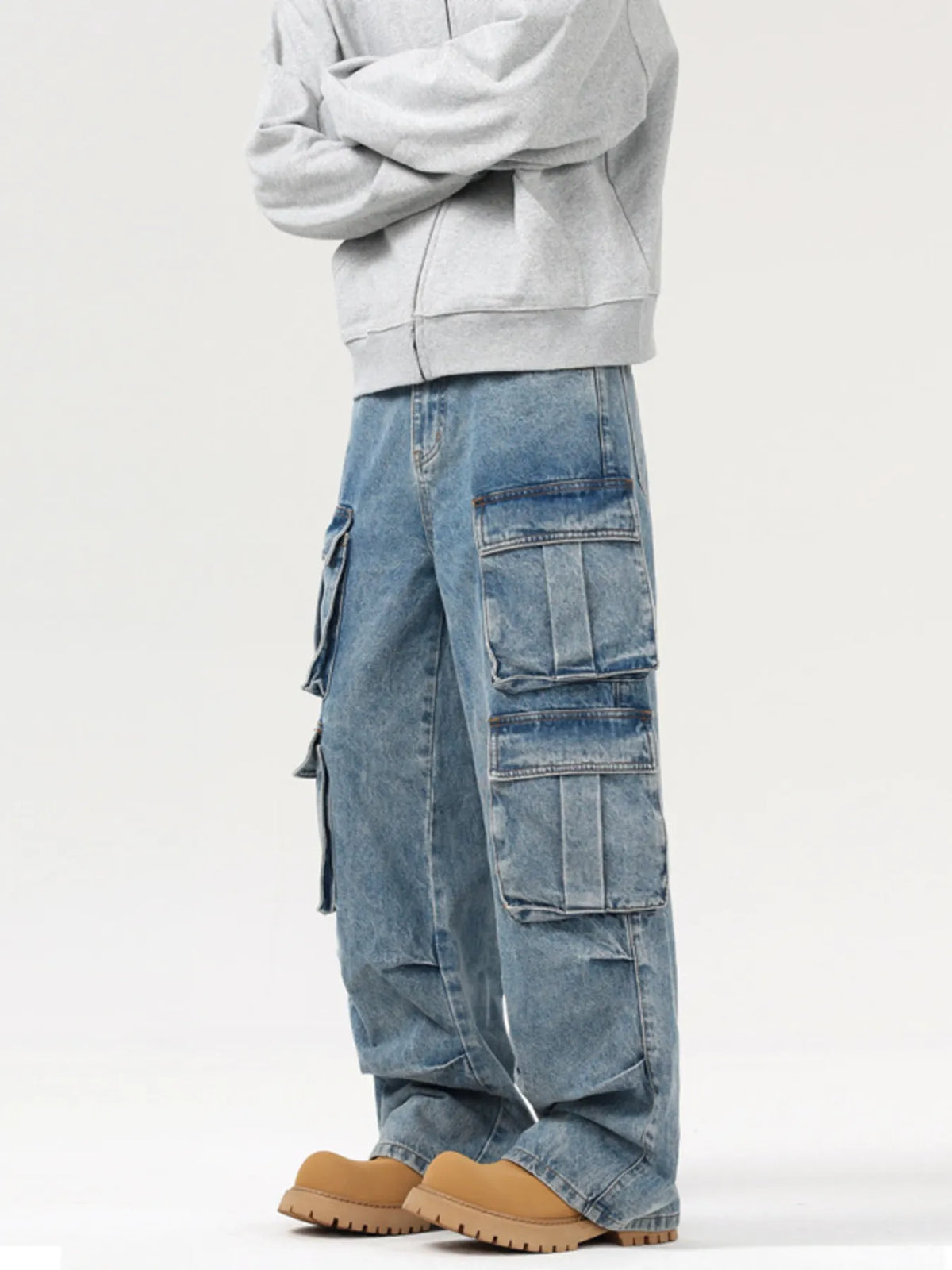 Blue washed cargo jeans with stacked patch pockets on the left leg, wide fit