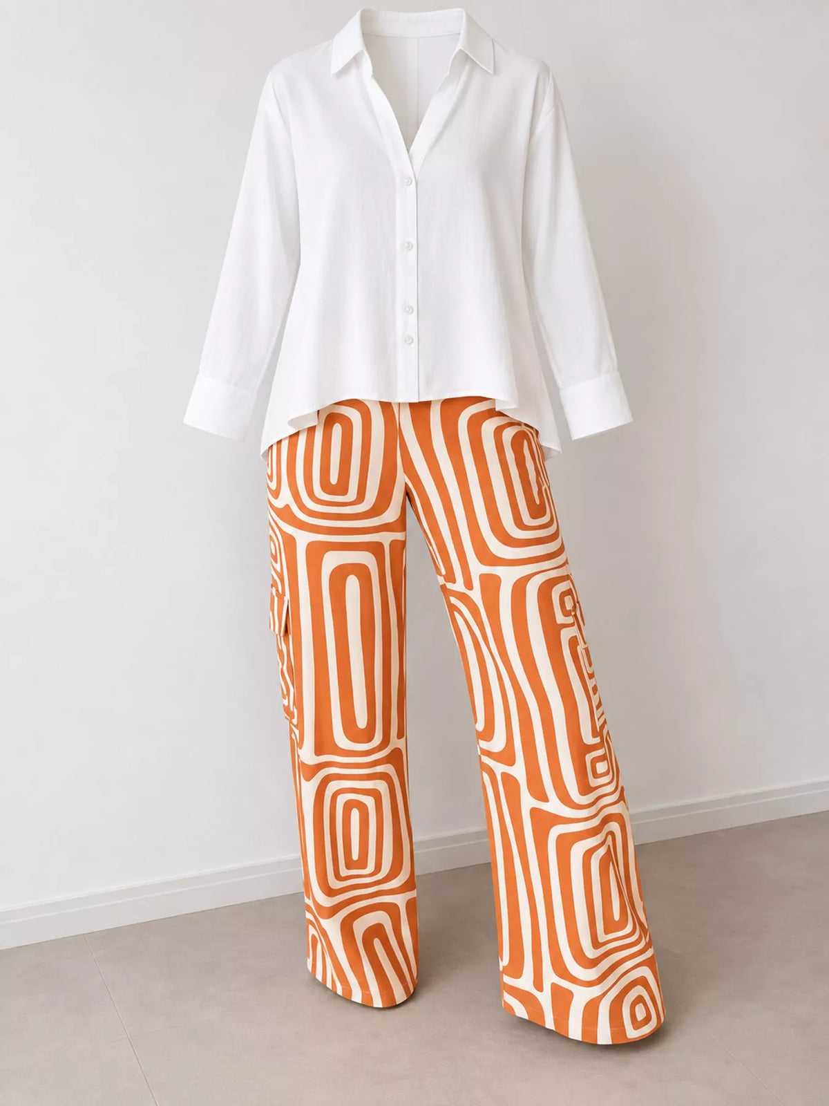 Button-down shirt and geometric pants set with orange abstract square pattern.