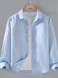 Light blue button-up long sleeve shirt with front buttons and collared neckline