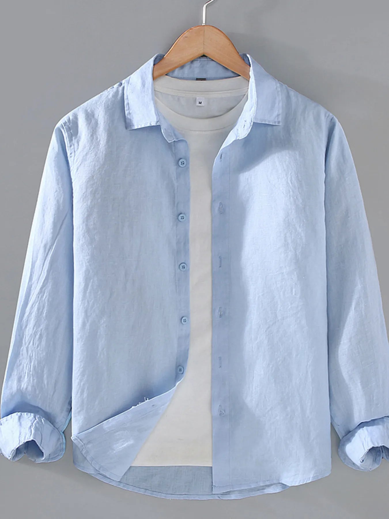 Light blue button-up long sleeve shirt with front buttons and collared neckline