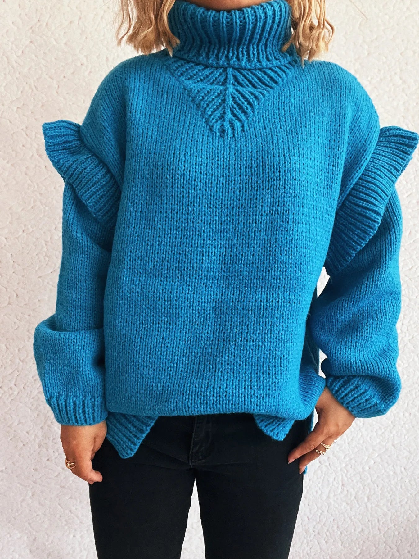 Blue ruffled turtleneck sweater with textured knit and wide sleeve ruffles