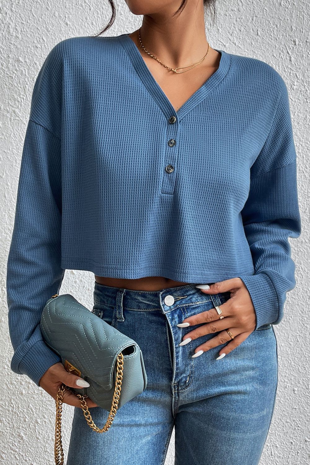 Dusty blue cropped V-neck raglan sleeve blouse with three-button placket