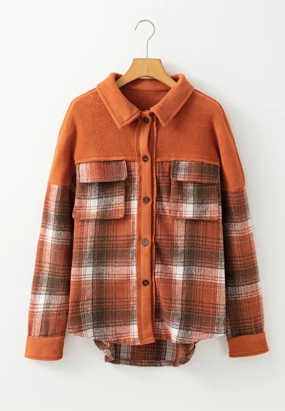 Rust orange plaid button-up long sleeve jacket on a hanger with patch chest pockets
