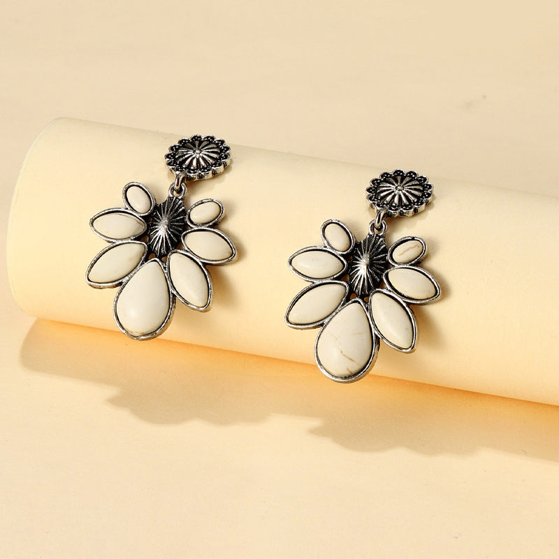 Silver-tone flower earrings with five white teardrop petals and ornate round tops
