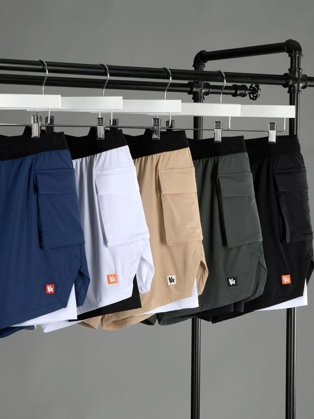 Drawstring shorts, assortment of tan, white, black, royal blue, and sage on hangers