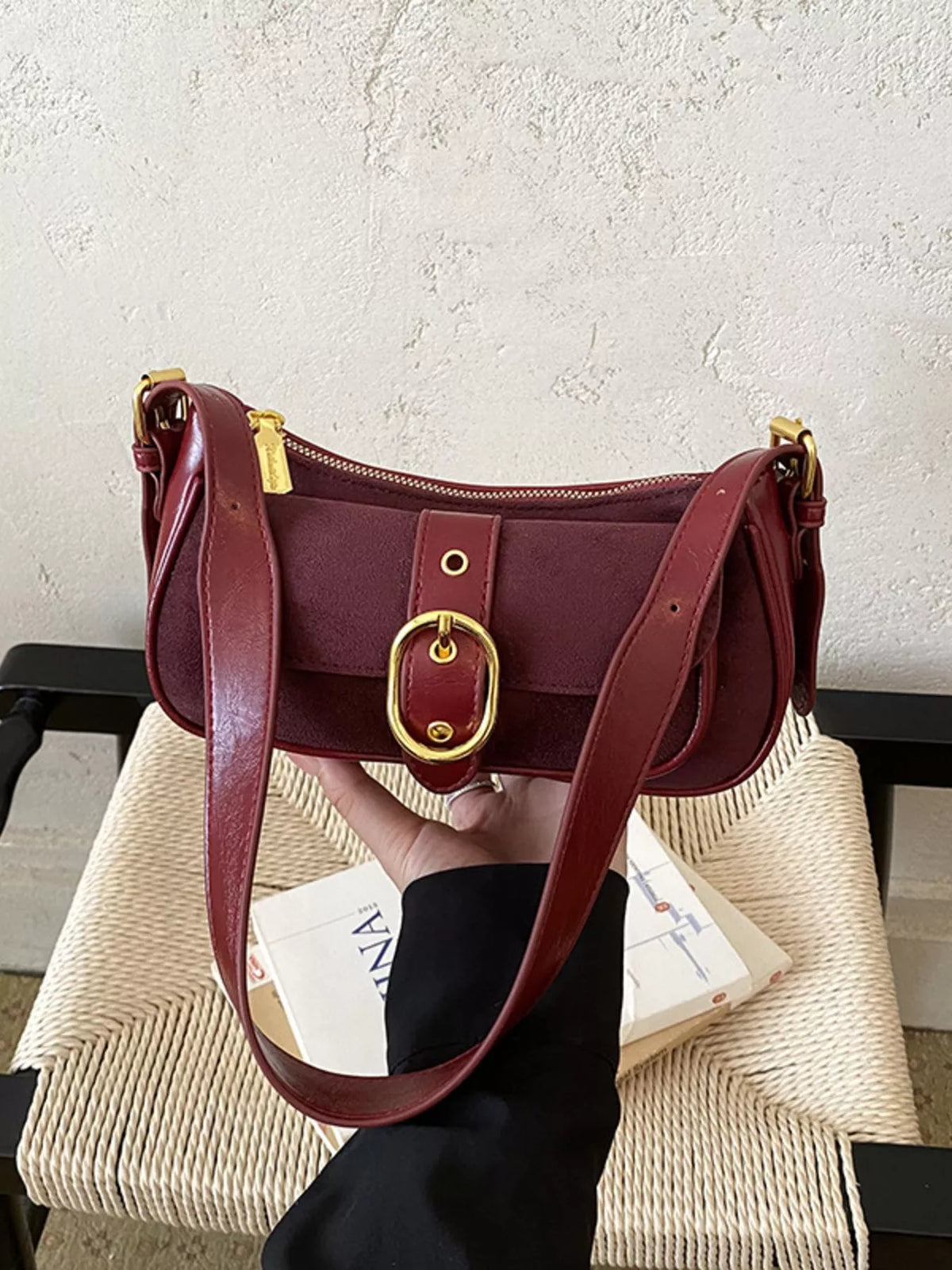 Wine red suede shoulder bag with double straps, flap front, and gold-tone buckle clasp