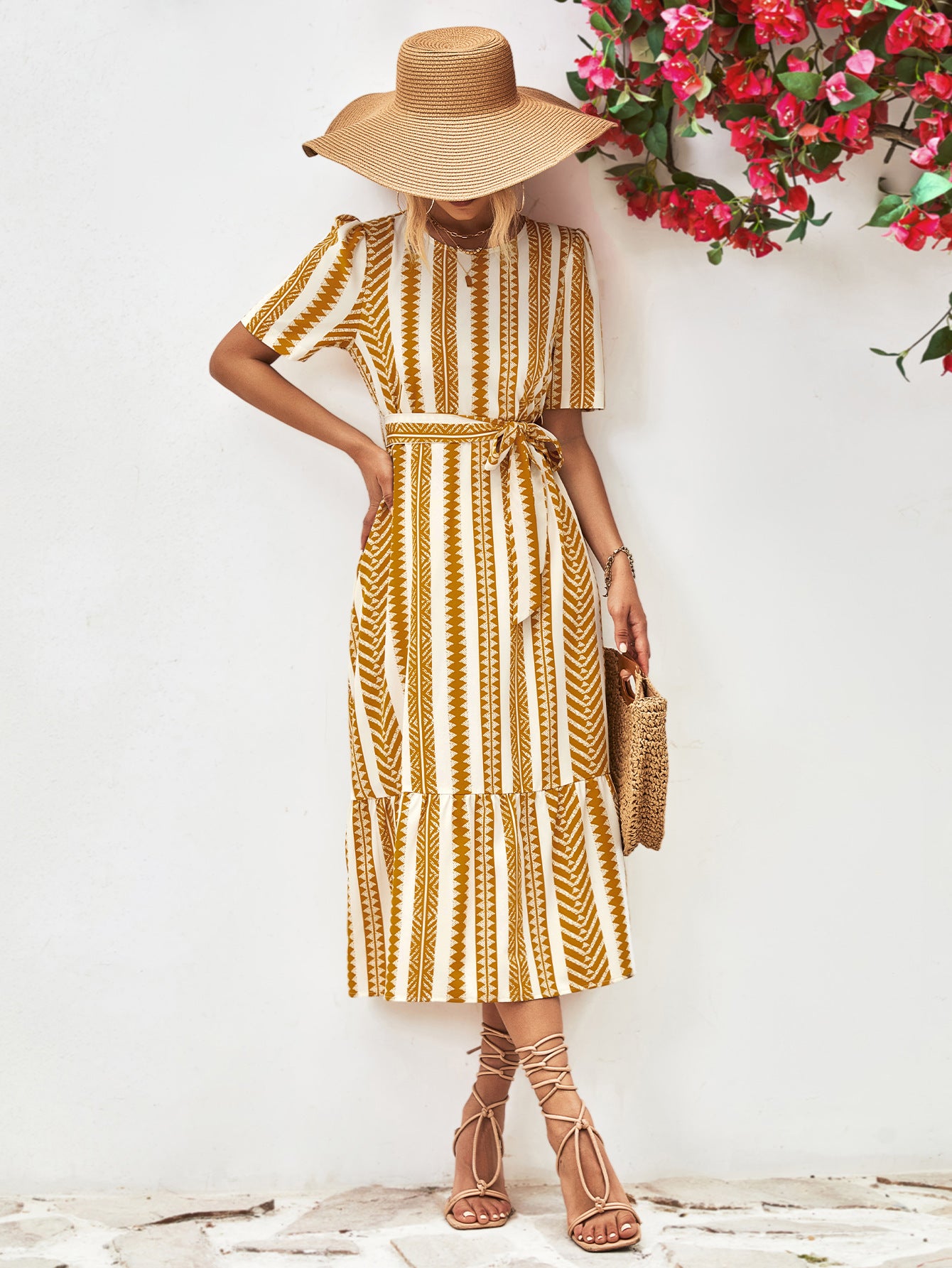 Gold striped round-neck puff sleeve dress with tied waist belt, full-length front view.