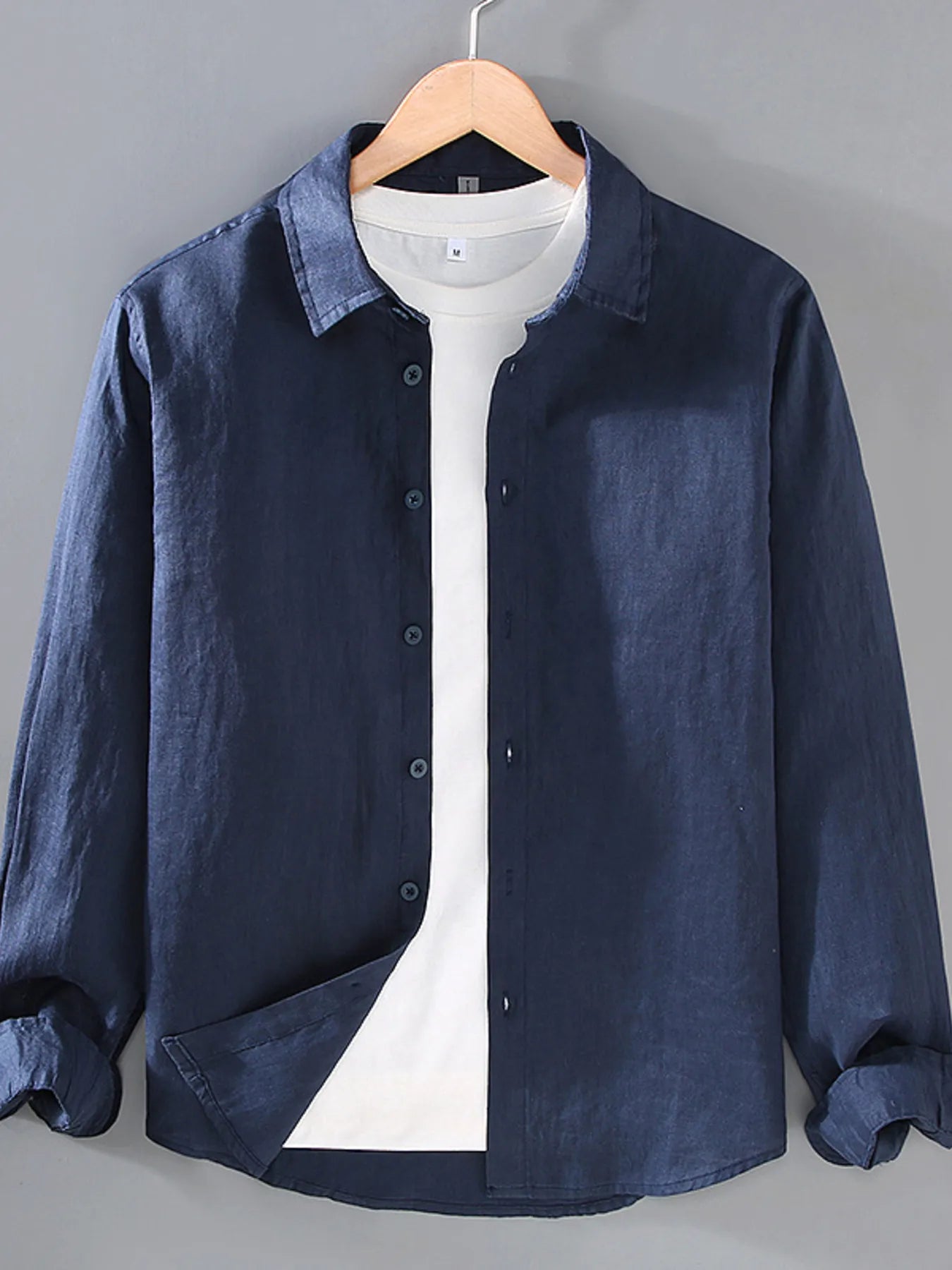 Dark blue button-up long sleeve shirt with button placket and collared neckline