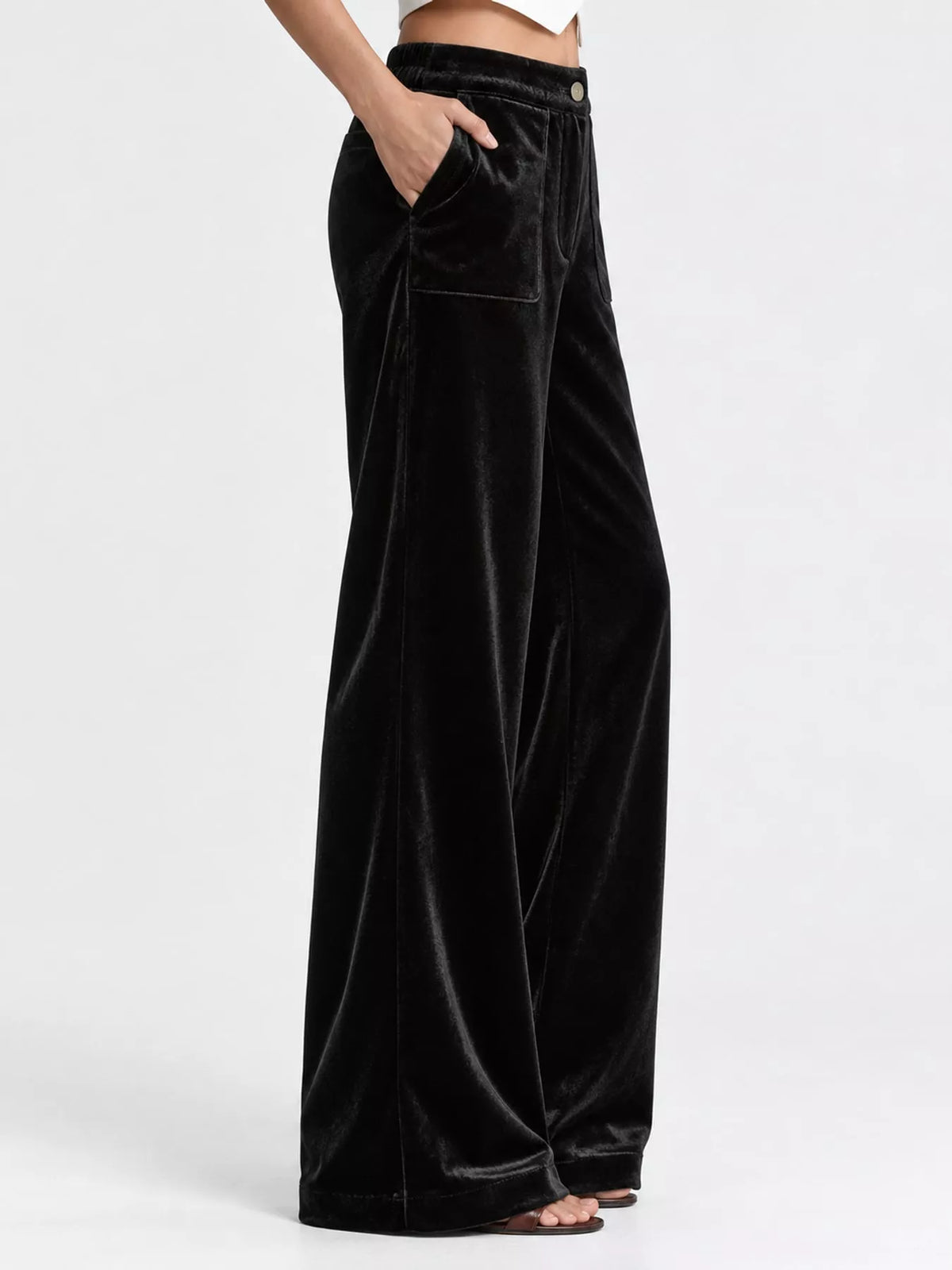 Black velvet high-waisted wide-leg pants with front pockets and button closure