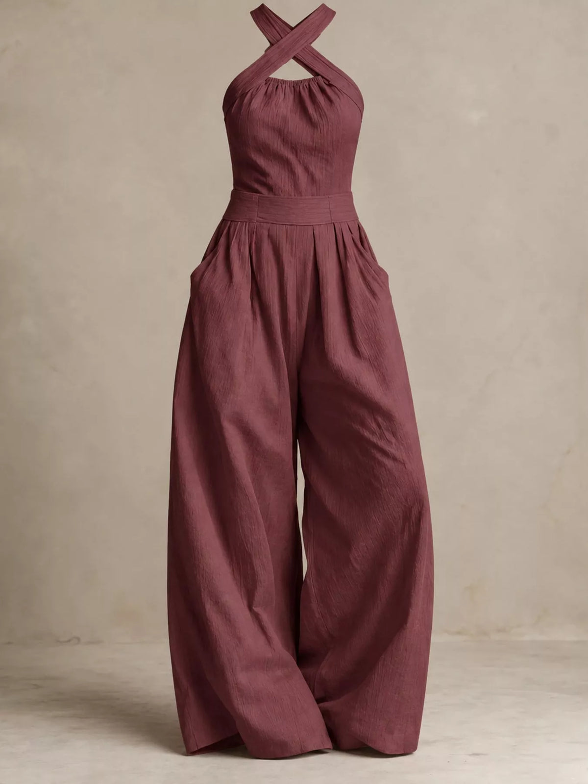 Burgundy halter linen jumpsuit with crisscross back and gathered waist wide legs