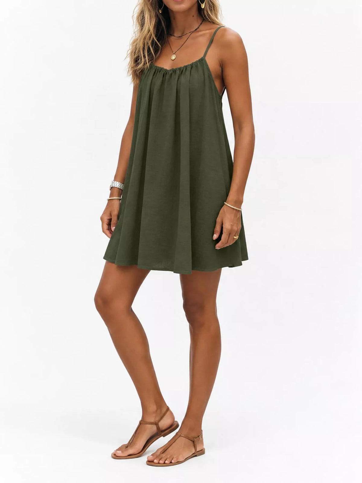 Olive green spaghetti-strap ruched mini dress with gathered bodice and flared skirt