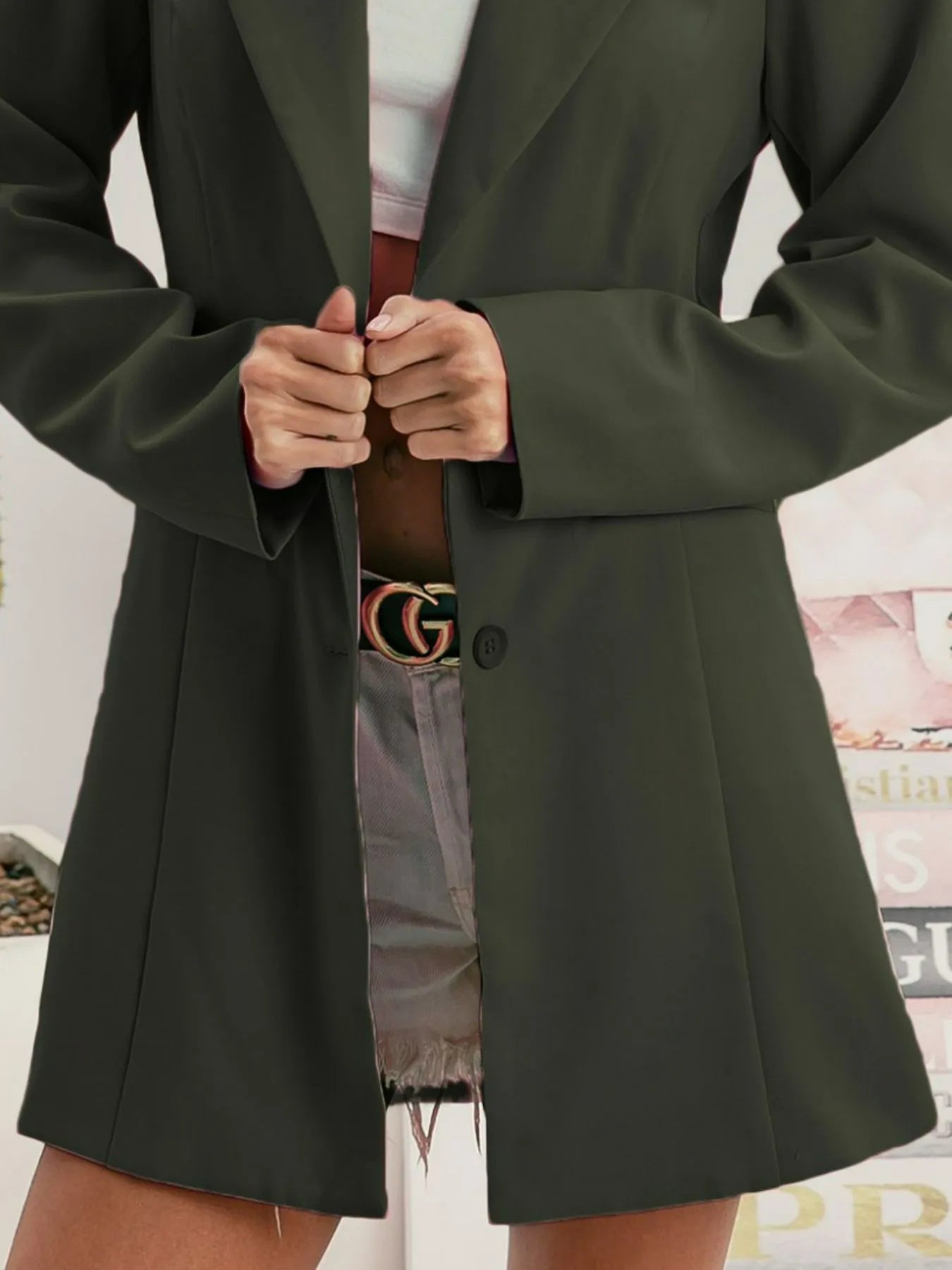 Olive blazer front with single row buttons and welt pocket detail