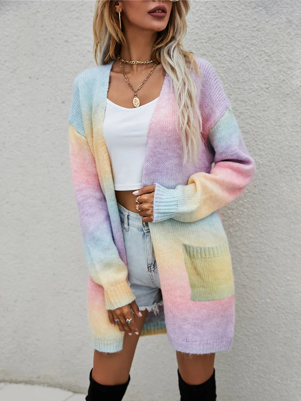 Pastel rainbow gradient open-front cardigan with long sleeves and side pockets, fuzzy knit.