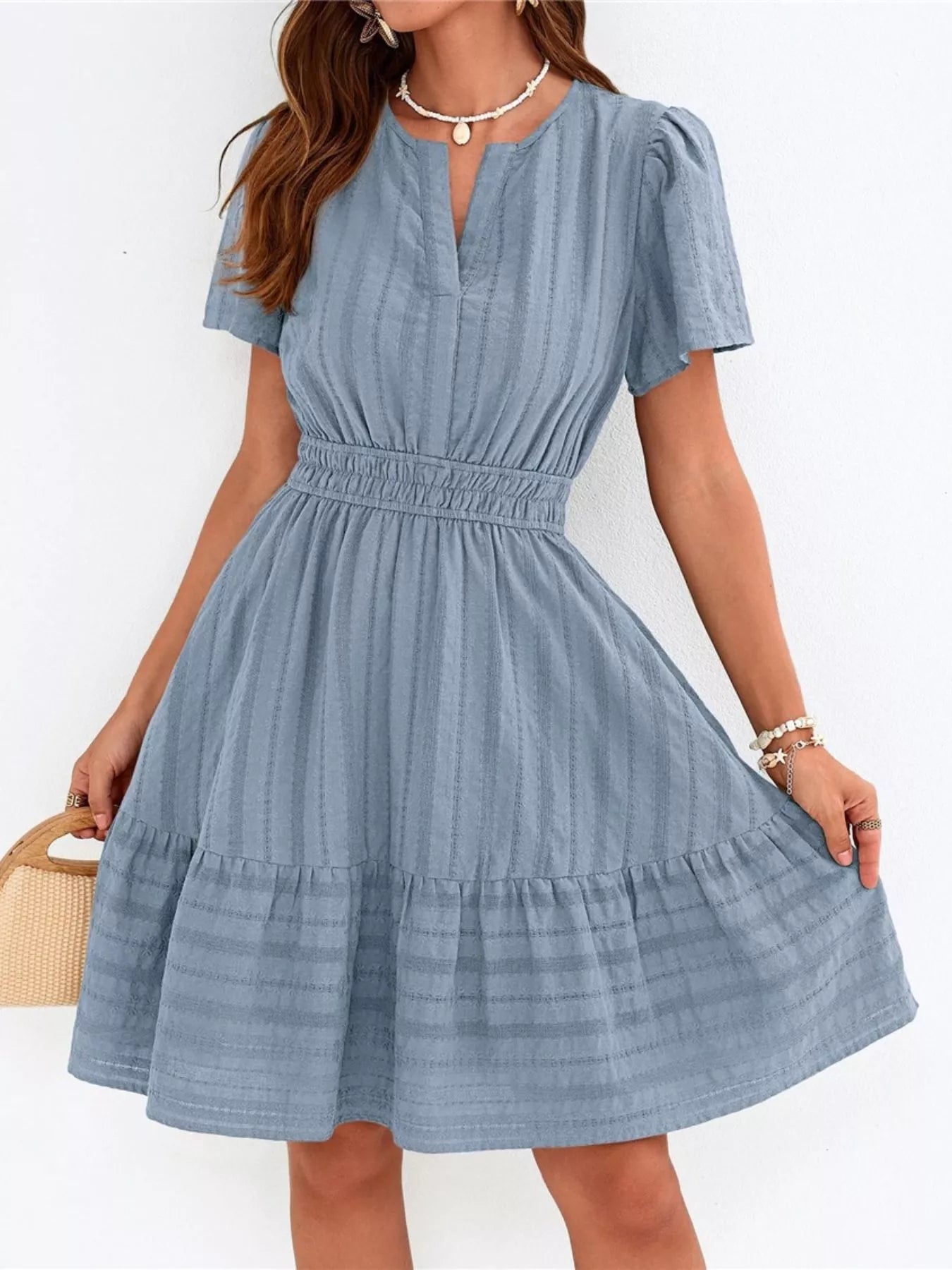 Dusty blue short-sleeve tiered dress with smocked waist and V-neck