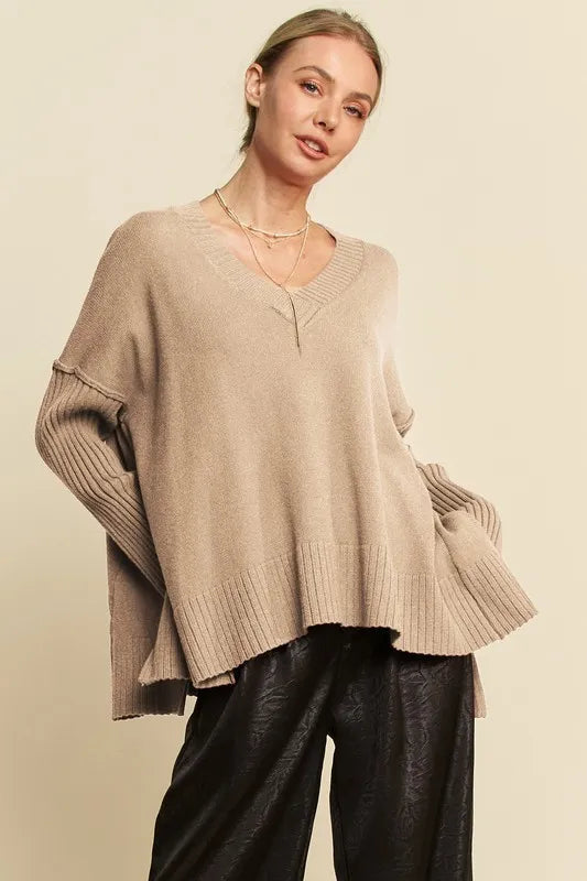 Tan ribbed V-neck sweater with side slits and bell sleeves