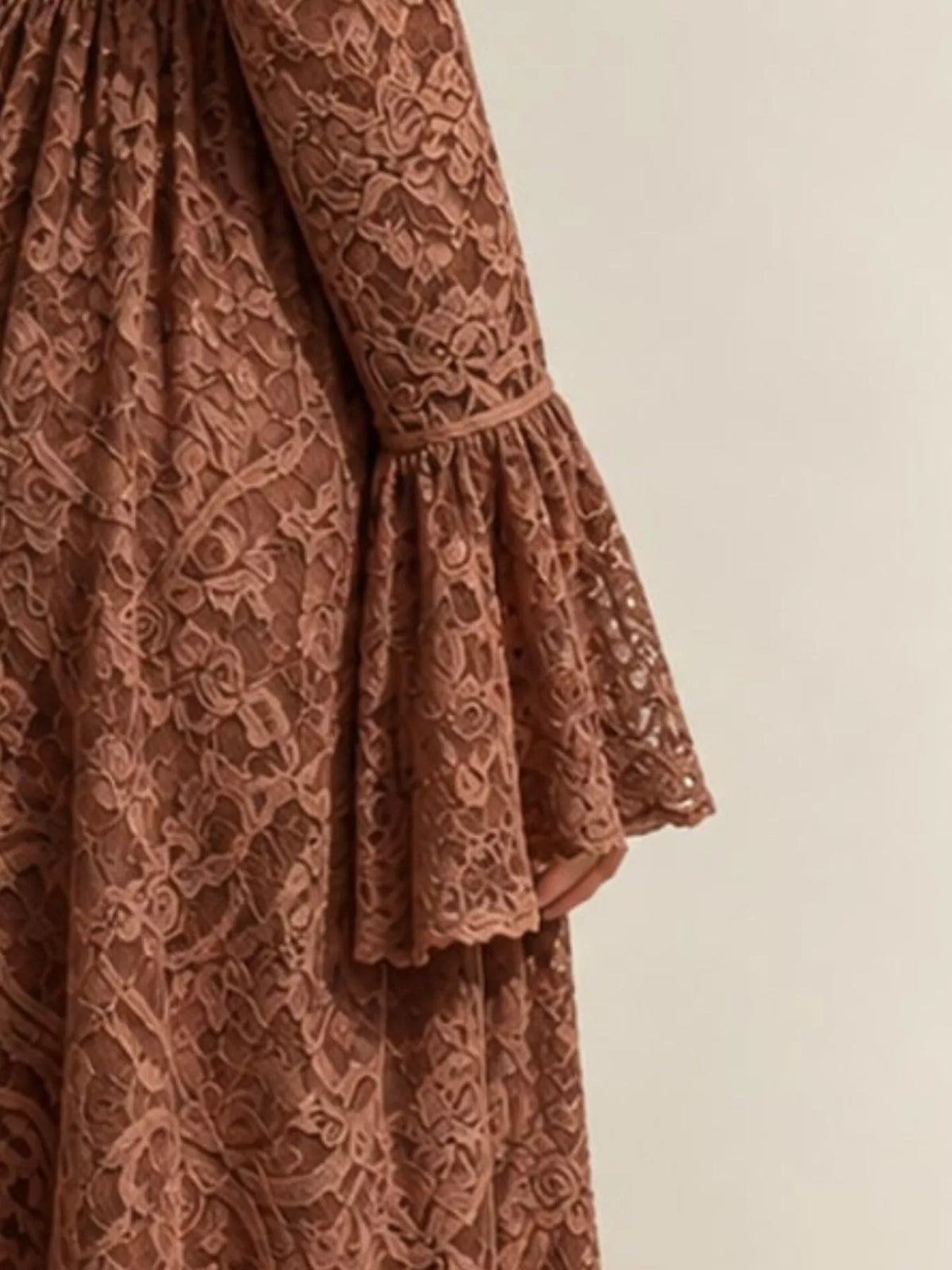 Brown lace maxi dress with dense floral lace overlay and tiered flared sleeves.
