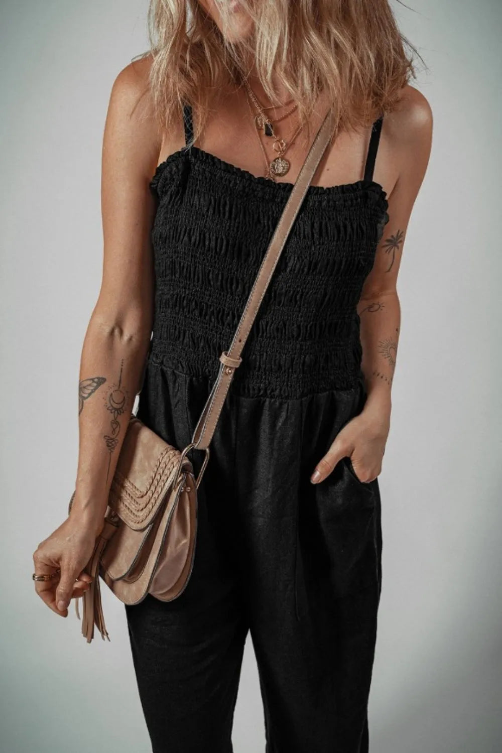 Black smocked spaghetti strap wide-leg jumpsuit with ruched bodice detail