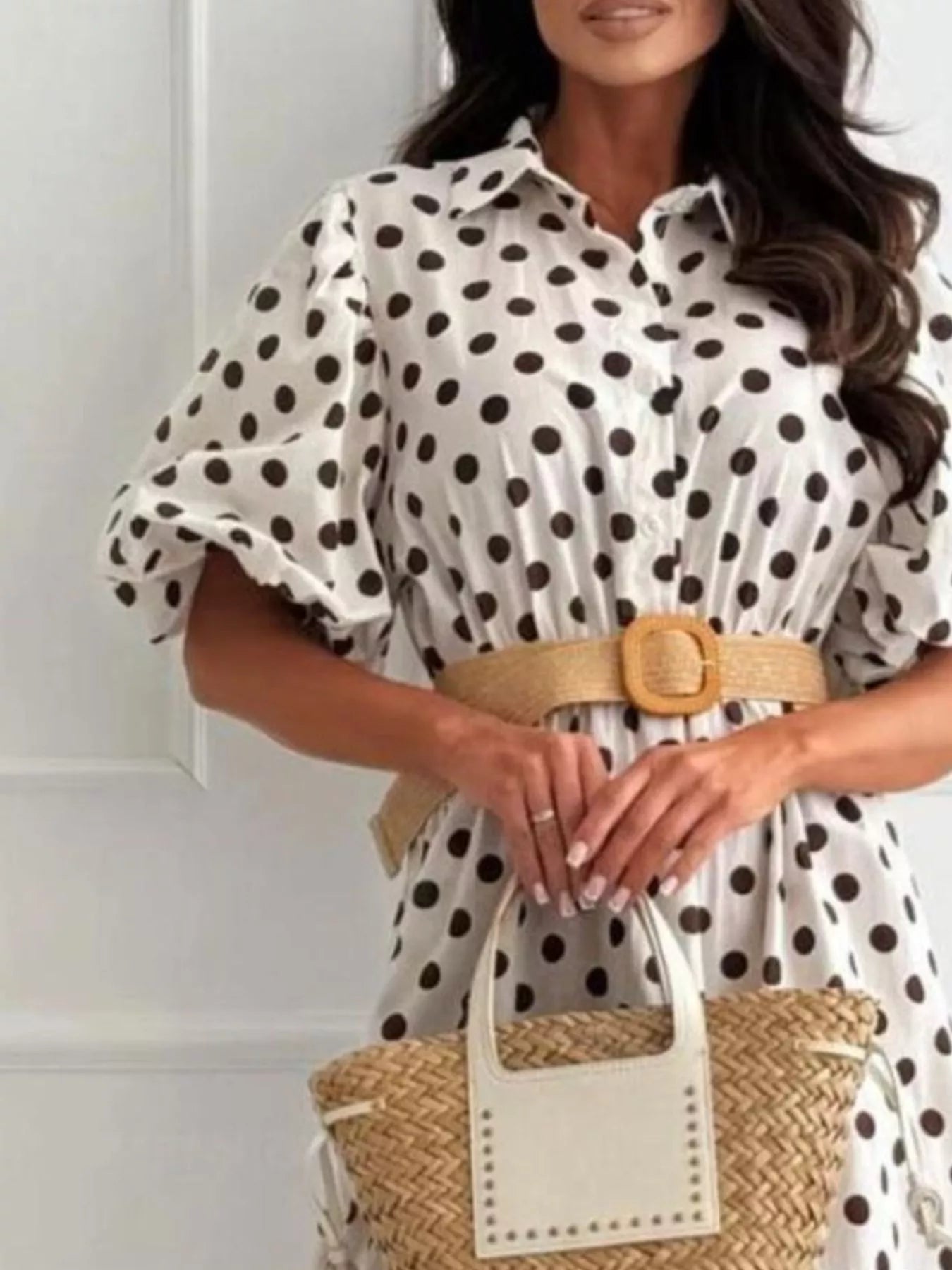 White polka-dot puff-sleeve midi dress with button front and tan waist belt, front view.