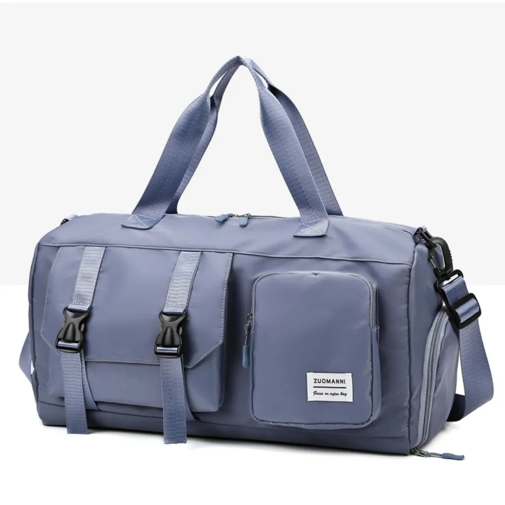Large multi-pocket travel duffle bag in light indigo with front flap pocket and side zipper