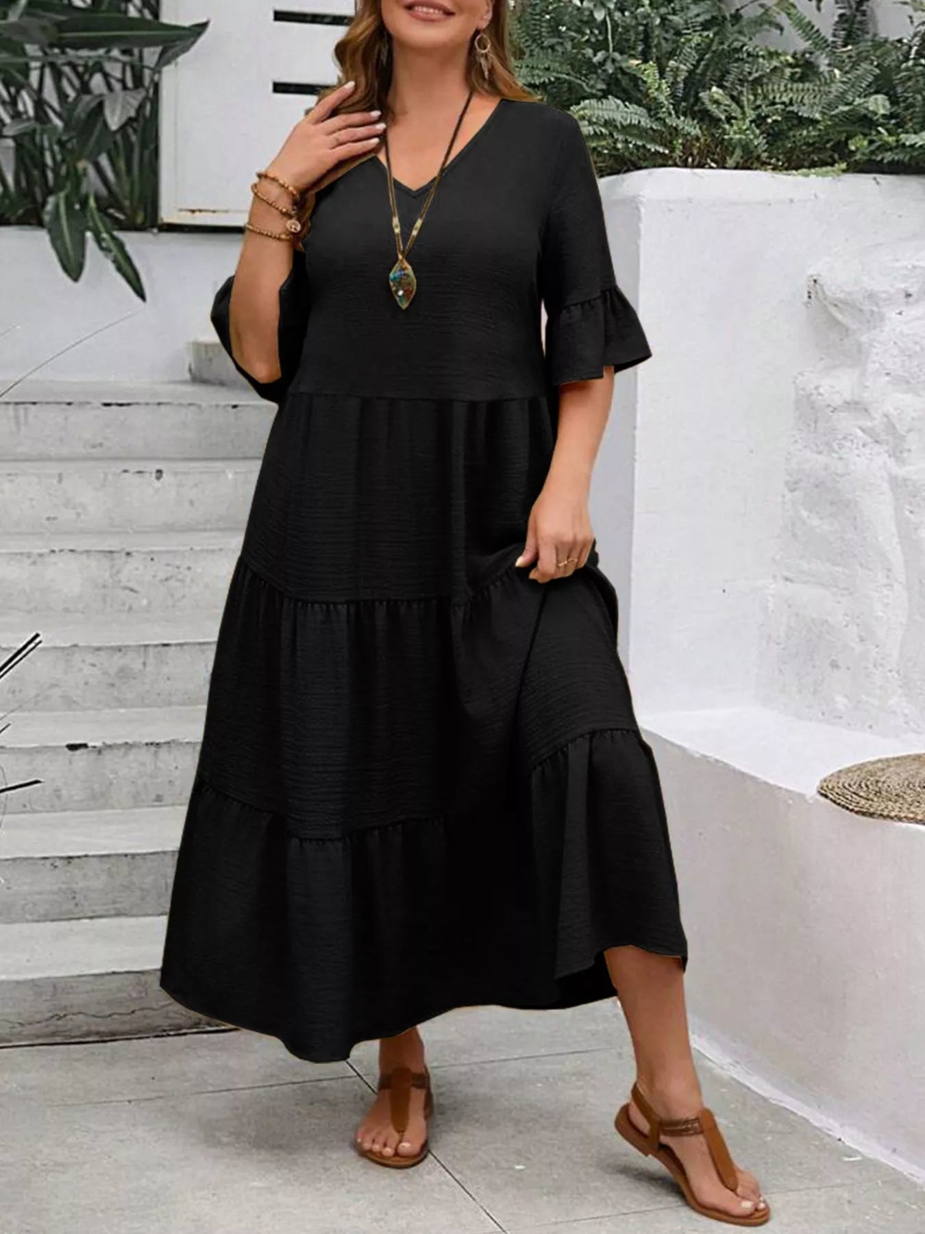 Black tiered midi dress with ruffle sleeves and gathered tiered skirt, V-neck