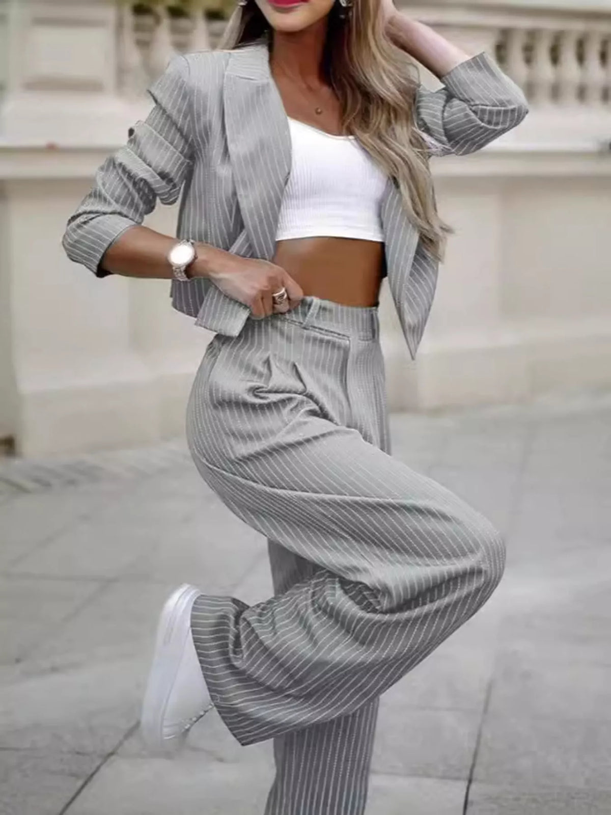 Light gray pinstripe wide-leg pants with cropped striped blazer and matching belt