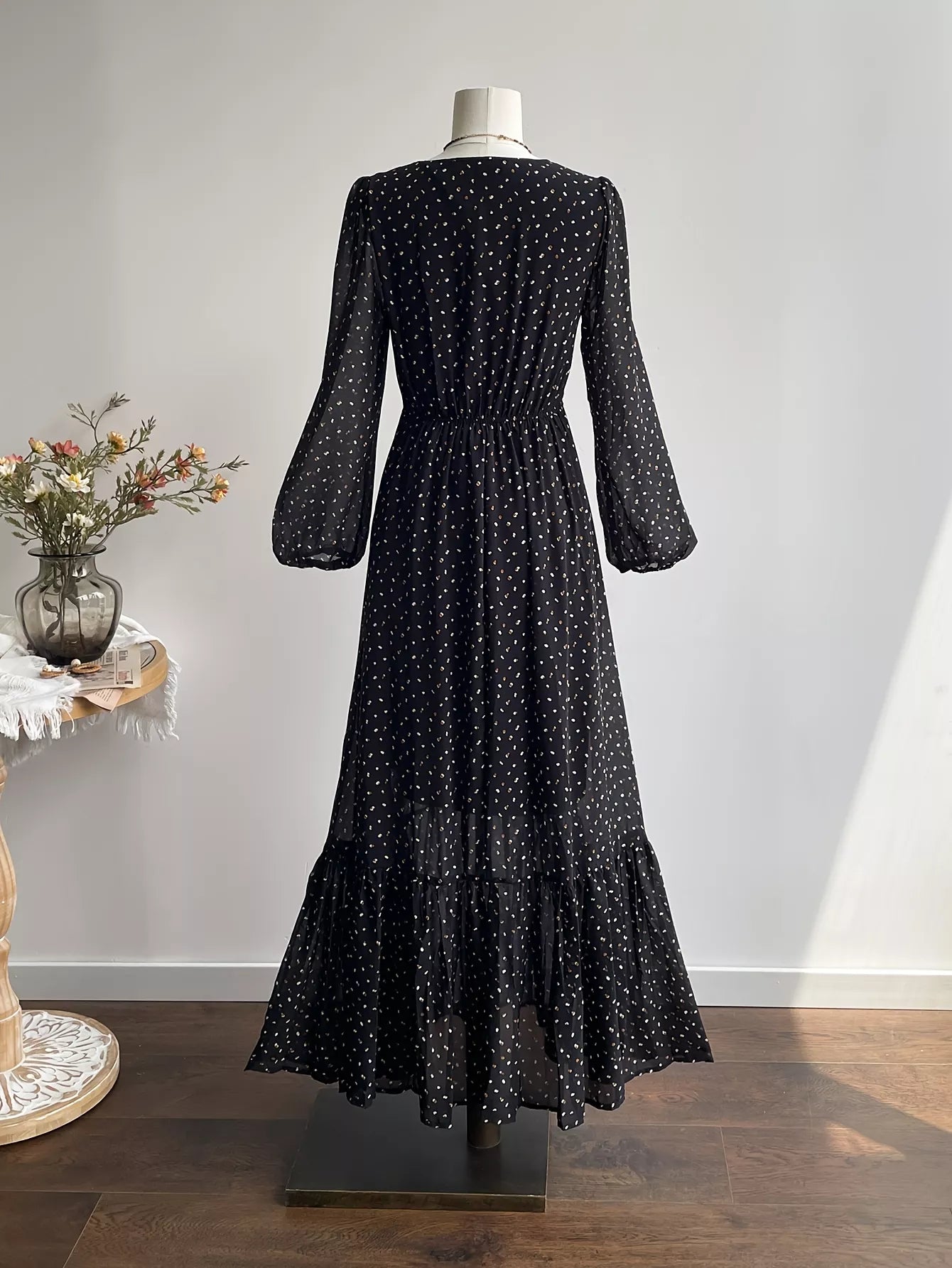 Black polka dot maxi dress back view with long sleeves and gathered waist