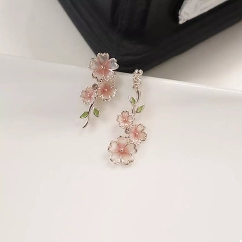 Asymmetrical blush pink flower drop earrings with leaf accents and two floral drops