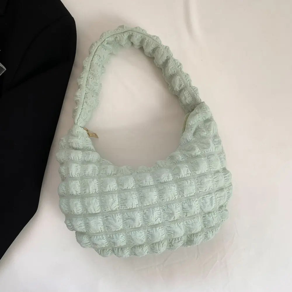 Light green textured small hobo handbag with open top and braided handle