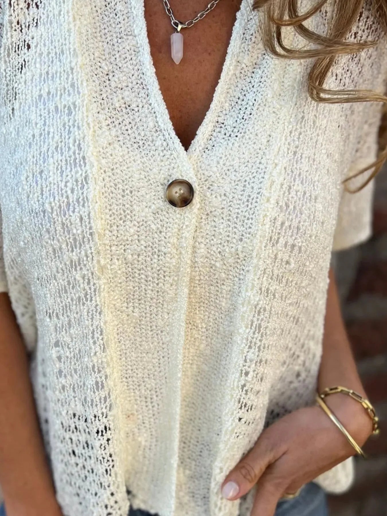 White openwork cardigan front, V-neck with single button closure and textured knit