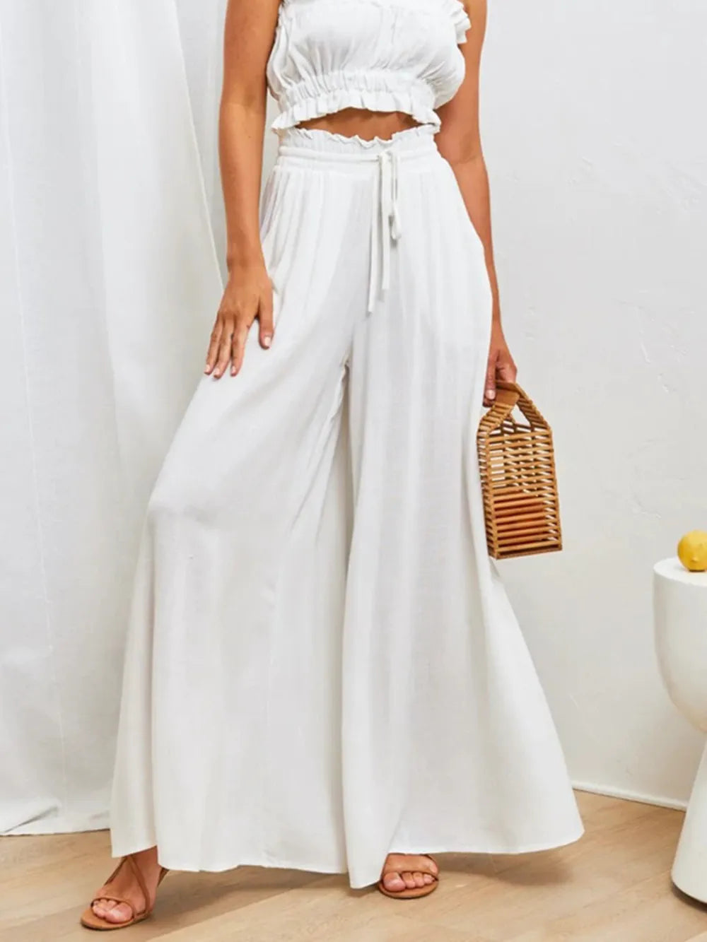 High-waist wide-leg pants in white with drawstring waist and loose wide-leg silhouette