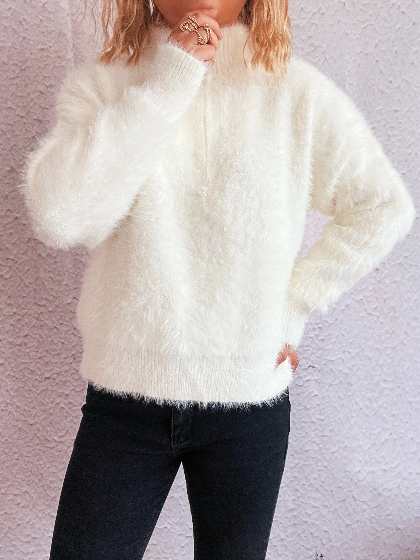 White fuzzy half-zip sweater with quarter-zip collar and long sleeves