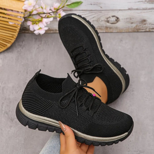 Black lace-up athletic sneakers with mesh upper and chunky outsole