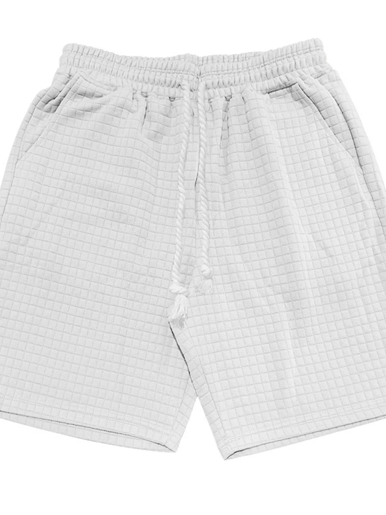 White drawstring shorts with elastic waistband and textured knit fabric