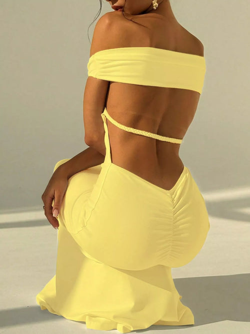 Yellow off-shoulder maxi dress with open back and thin straps over ruched lower back.