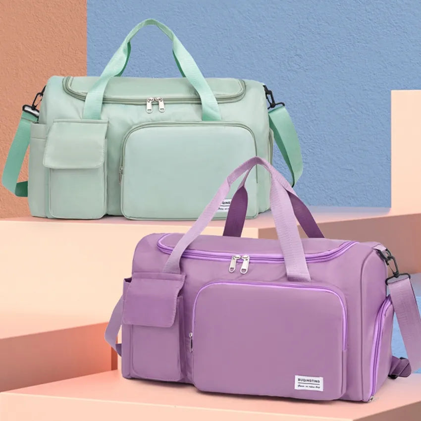 Large travel duffle bag with detachable straps, mint green with front zip pocket.