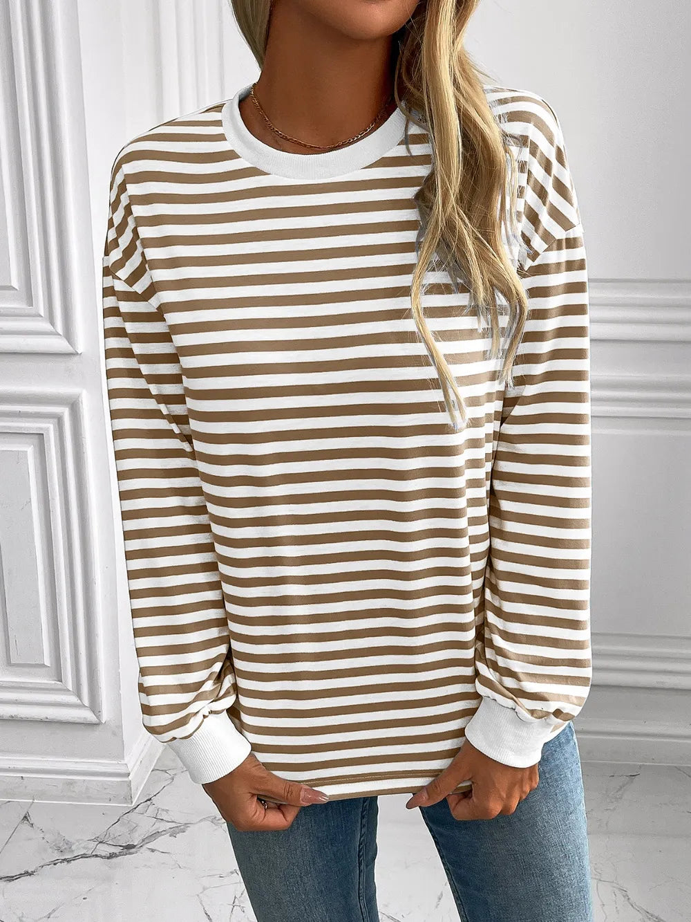 Striped long-sleeve sweatshirt with round neck, tan and white stripes, ribbed cuffs and hem