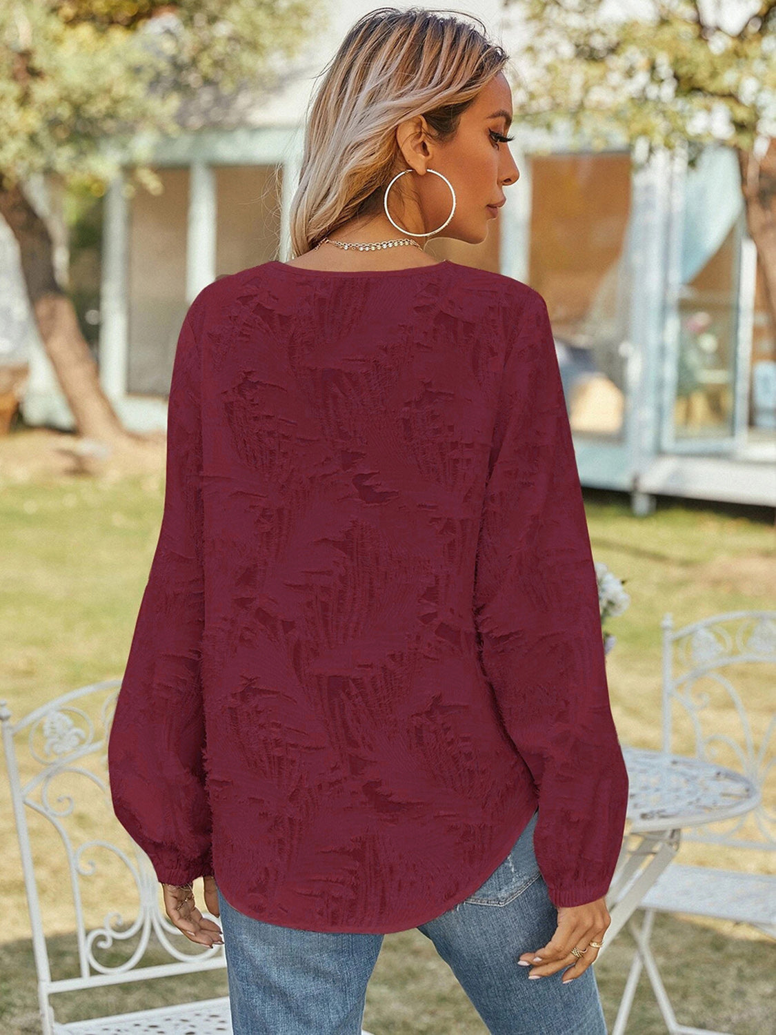 Burgundy V-neck long-sleeve blouse from back, loose silhouette with puff sleeves
