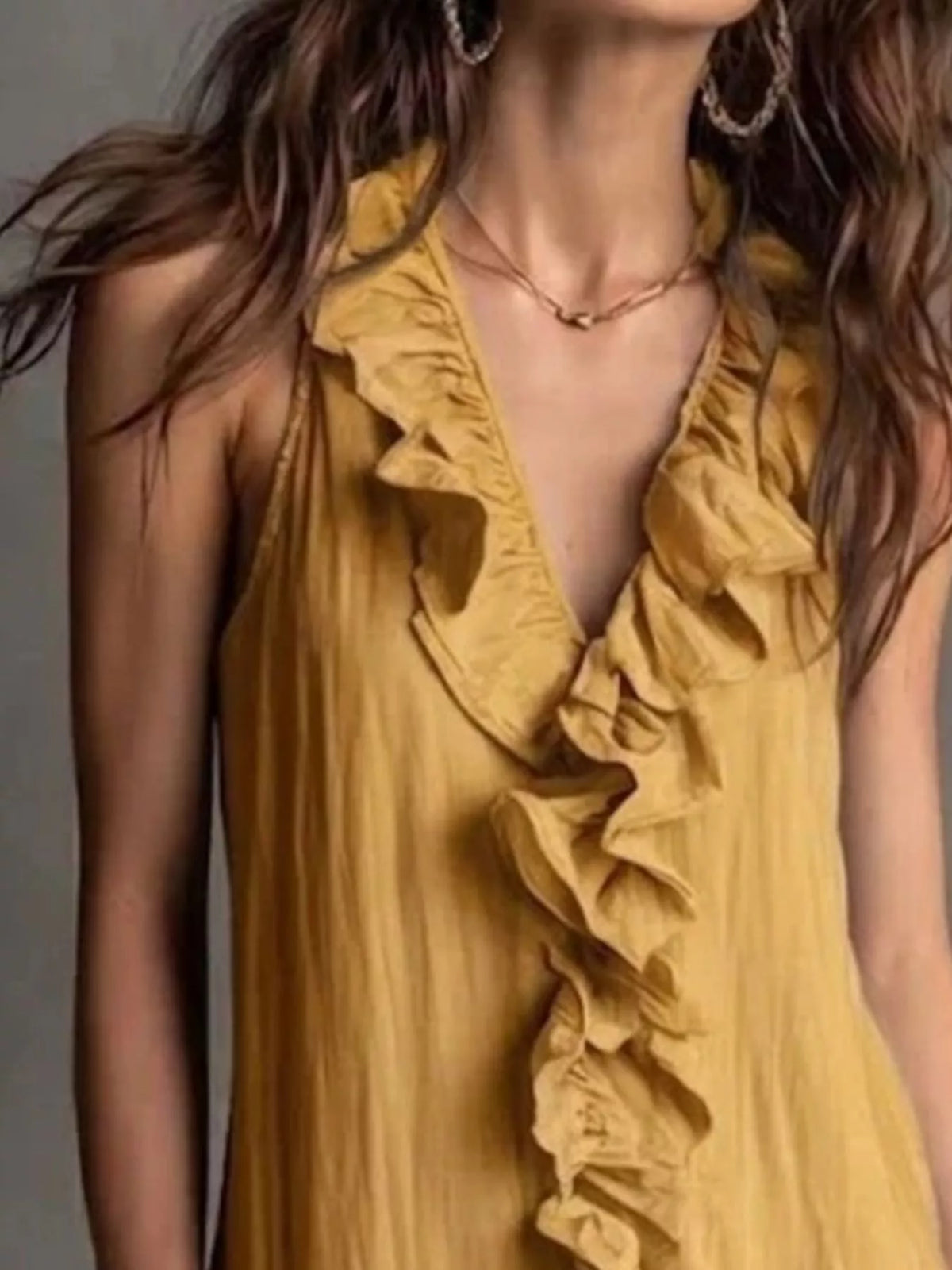 Women's sleeveless ruffle V-neck midi dress close-up, layered ruffle placket