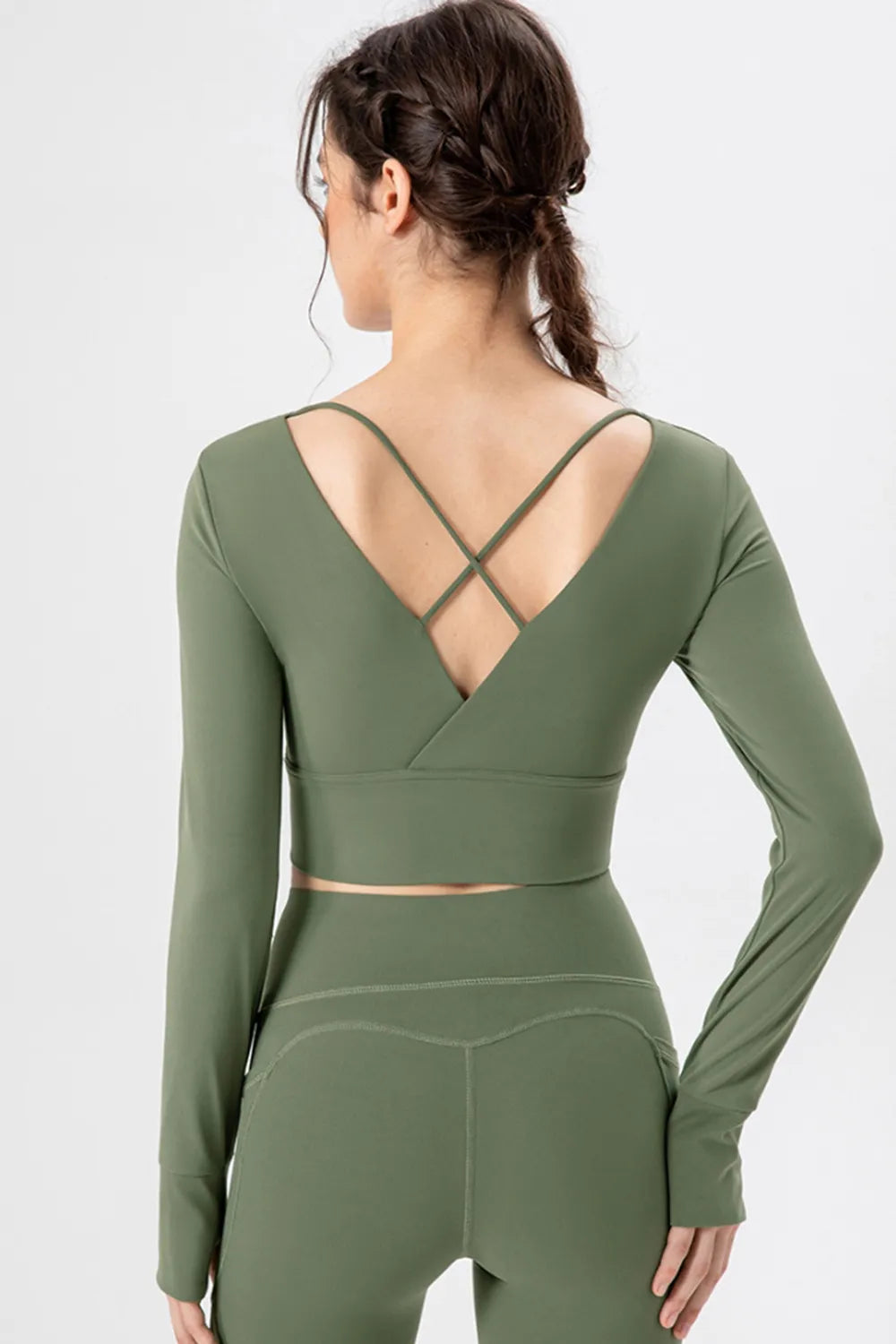 Back view of matcha green long-sleeve active crop T-shirt with crisscross straps