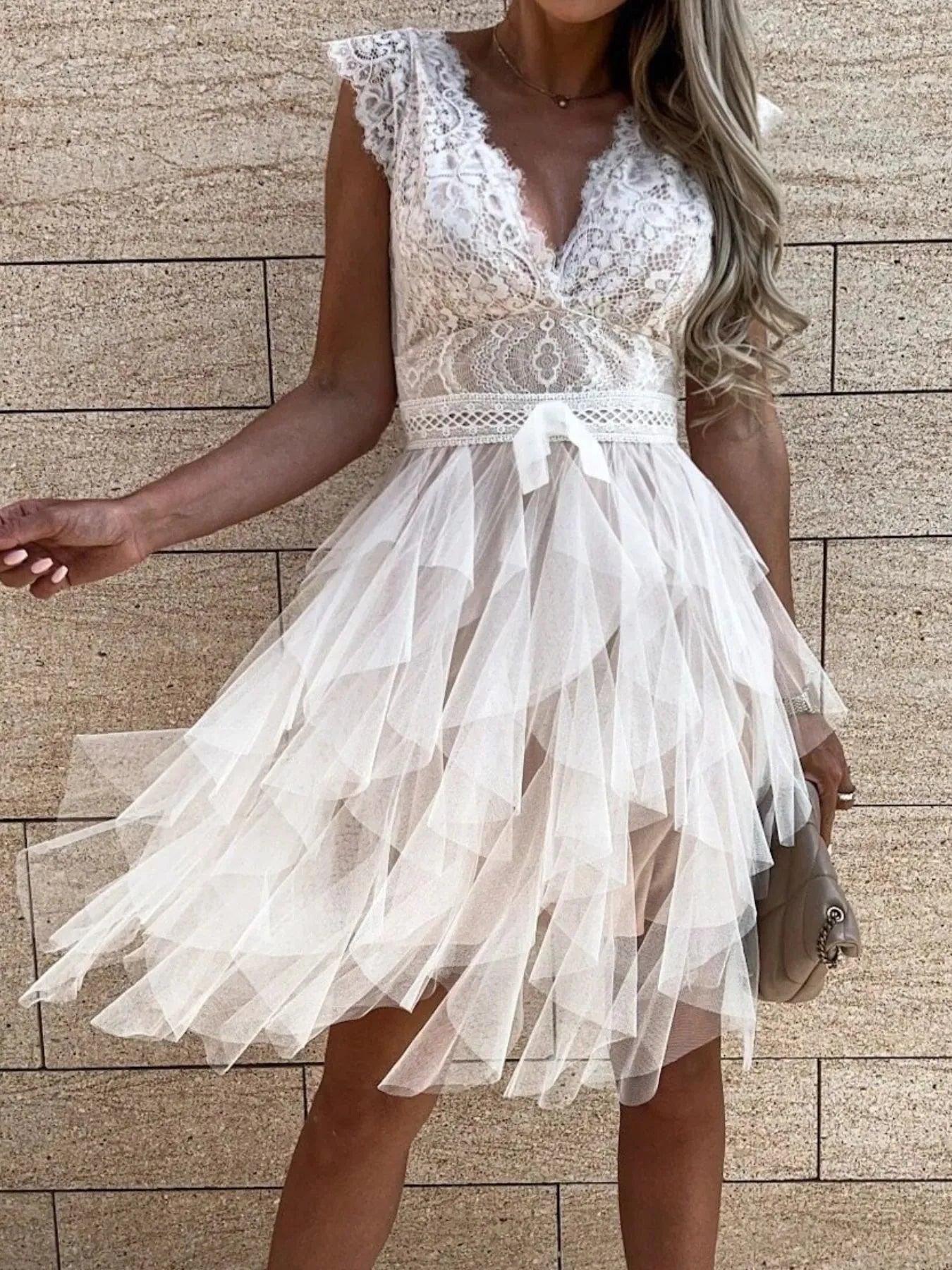 Lace V-Neck Ruffle Dress with belted waist and tiered tulle skirt in white.