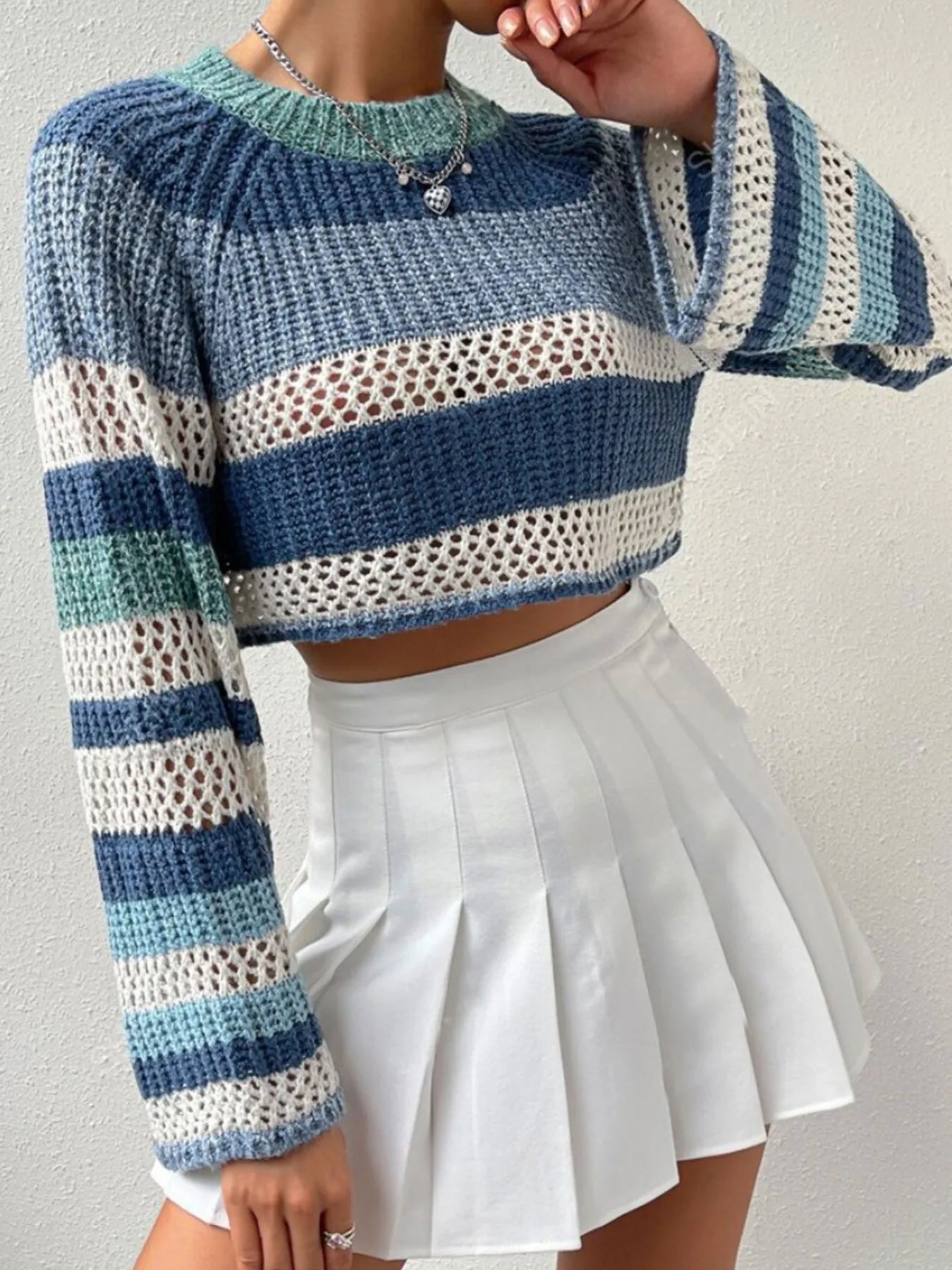 Striped color block crop sweater with long sleeves, ribbed collar, and open-knit texture