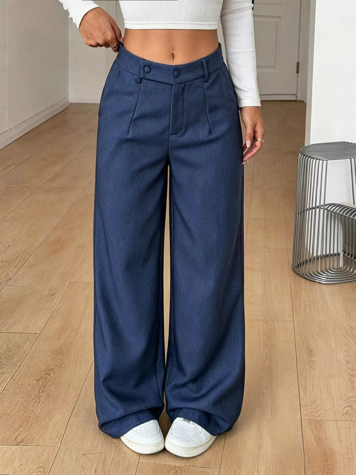 Navy high-waisted wide-leg pants with button front and front pockets.