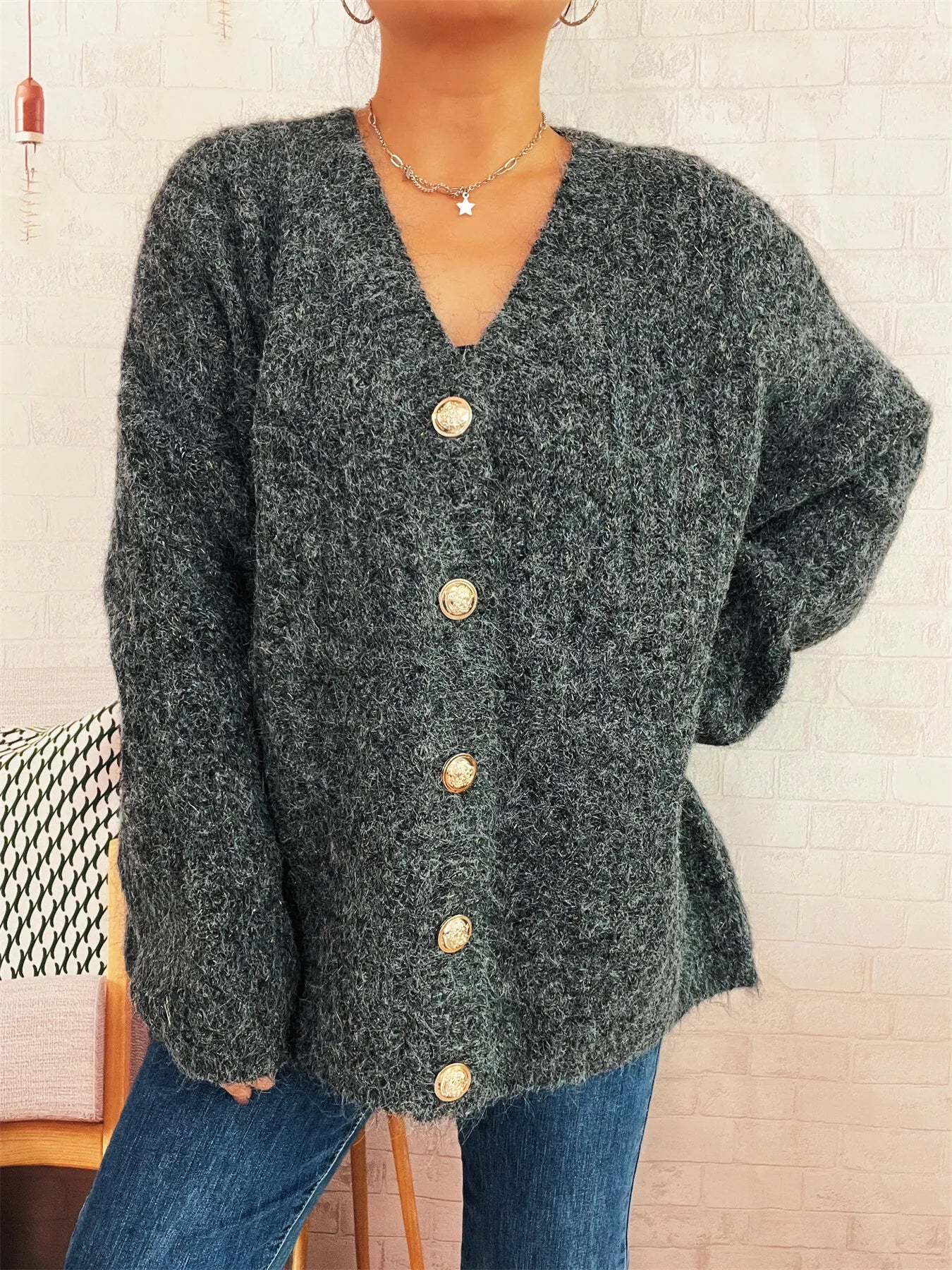 Dark gray knit button-up cardigan with V-neck and long sleeves, gold buttons at center