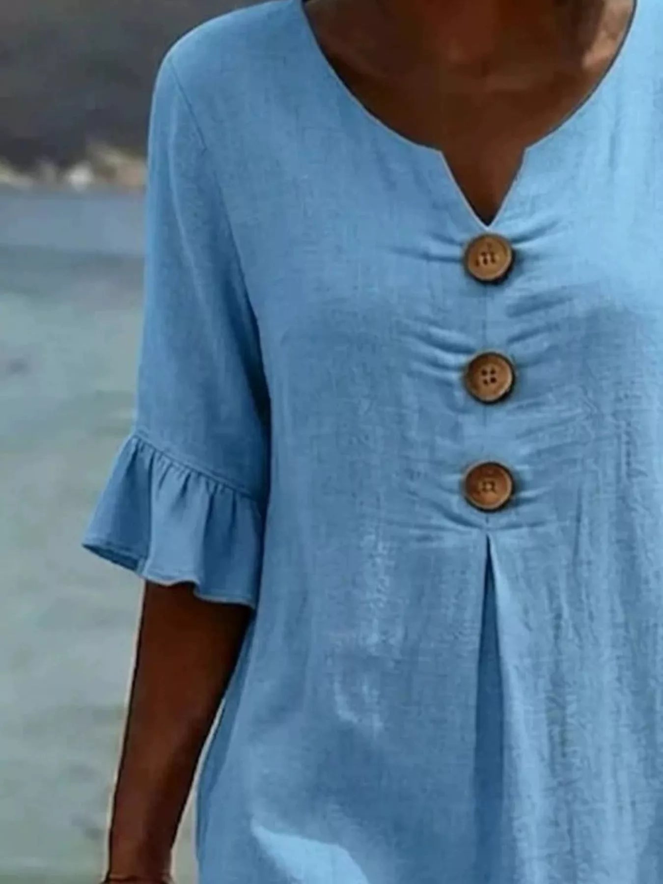 Light blue V-neck button-front midi dress with ruffle sleeves and three wood-tone buttons