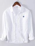 Plus size button-up long sleeve shirt, white with buttoned front and blue chest logo