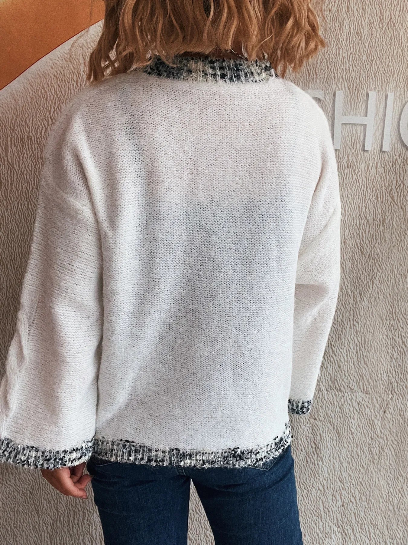 White round-neck sweater, contrast knit trim at collar and sleeve cuffs