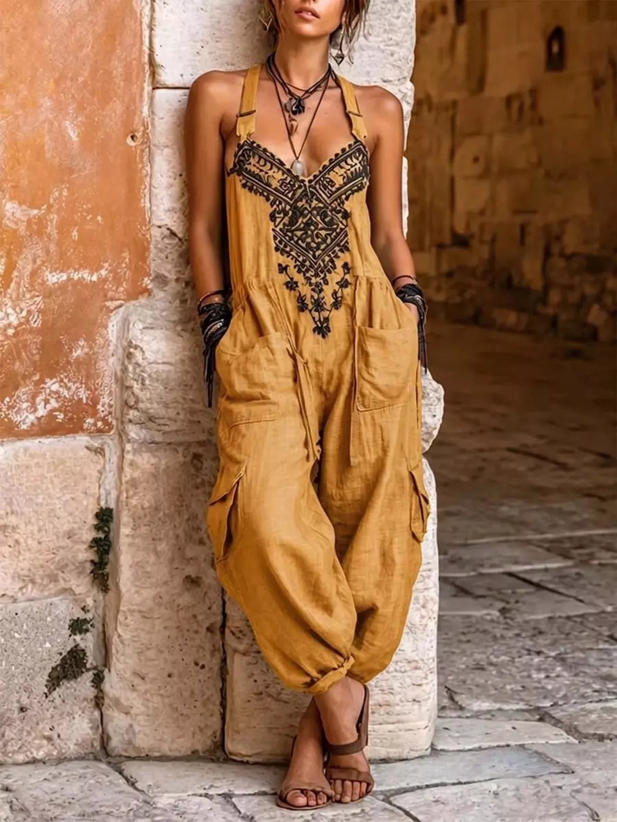 Orange embroidered sleeveless jumpsuit with cargo pockets and halter neckline