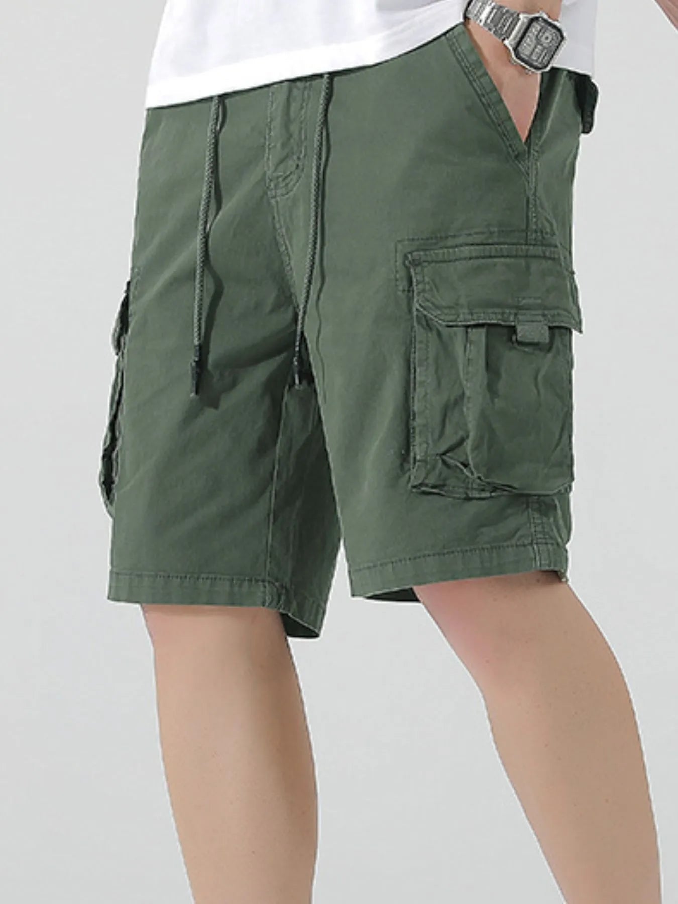 Green drawstring cargo shorts with layered cargo pocket detail on side